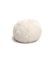 The Cojín de Lujo Iglú Ball by Intima Hogar is a round, fluffy, cream-colored pet bed with a soft shaggy texture, shown on a white background.
