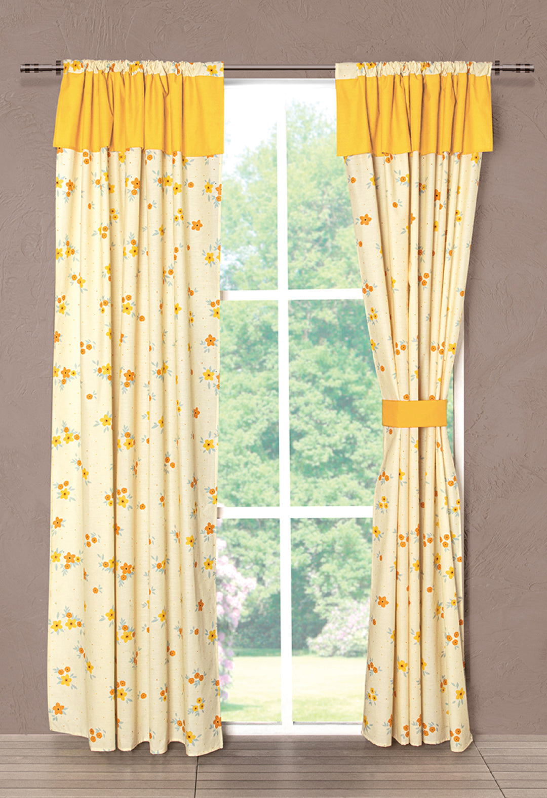 A window adorned with the Juego de Cortinas Girasoles by Intima Hogar features light beige curtains with a yellow floral pattern and solid yellow valances, tied back on one side, allowing natural light and a view of greenery.