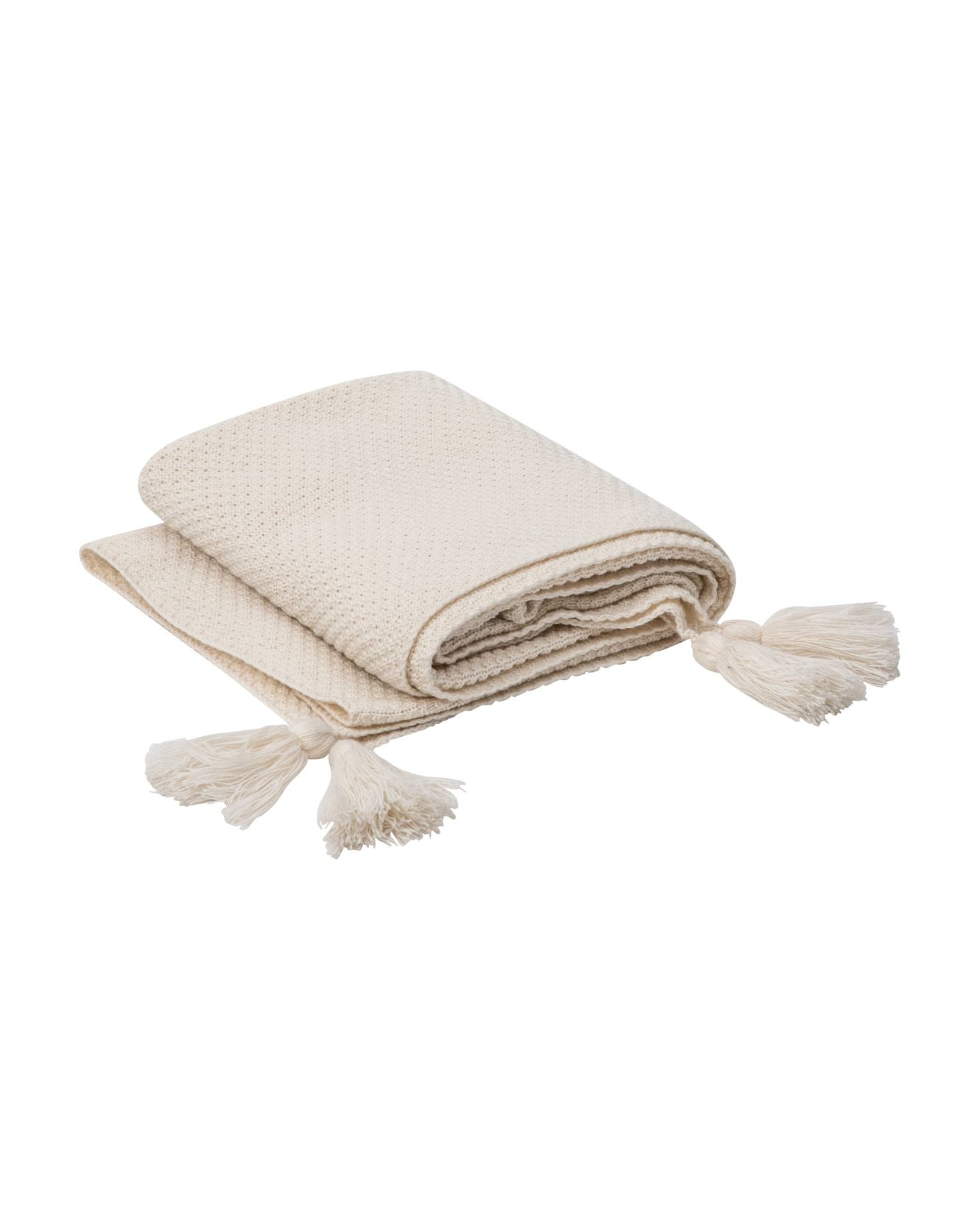 The Frazada de Lujo Chai Beige by Intima Hogar is a folded cream-colored throw with a textured pattern and large corner pompons, displayed on a white background.