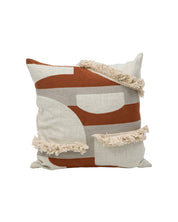 The Funda de Cojín Agadir by Intima Hogar features abstract rust, beige, and cream geometric patterns with textured cream fringe—an ideal funda boho or funda con flecos to add warmth and style to your space.