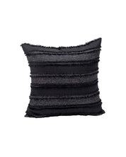 The Funda de Cojín Seúl by Intima Hogar features a square black design with horizontal dark gray stripes and fringed edges, adding a stylish touch to any space. Shown on a plain white background.