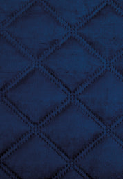 Close-up of the Intima Hogar Juego de Cobertor Velvet Lovett Azul, featuring a soft, velvety texture and a quilted diamond pattern with raised stitching.
